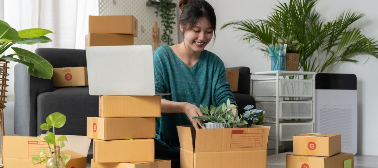 women smiling while packaging flowers