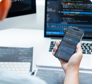 a man hand grabbing a phone while developing mobile app