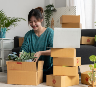 women smiling while packing a pot of flower