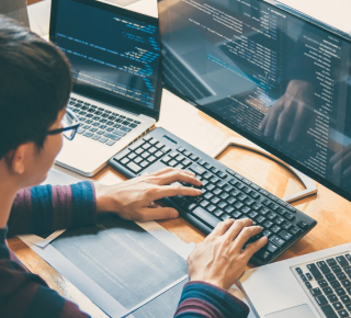 a man with glasses developing a website