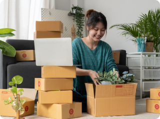 women smiling while packaging flowers